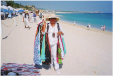 Women-beach-vendor-selling-her-wares-on-Medano-Beach-Cabo-San-Lucas-2010-She-buys-the.png